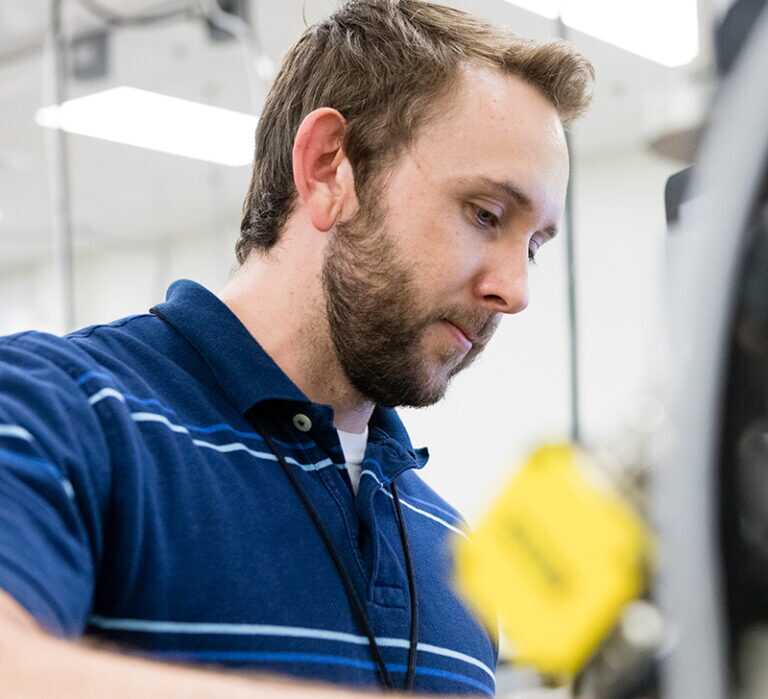 A close up of a worker operating a specialized device in a facility