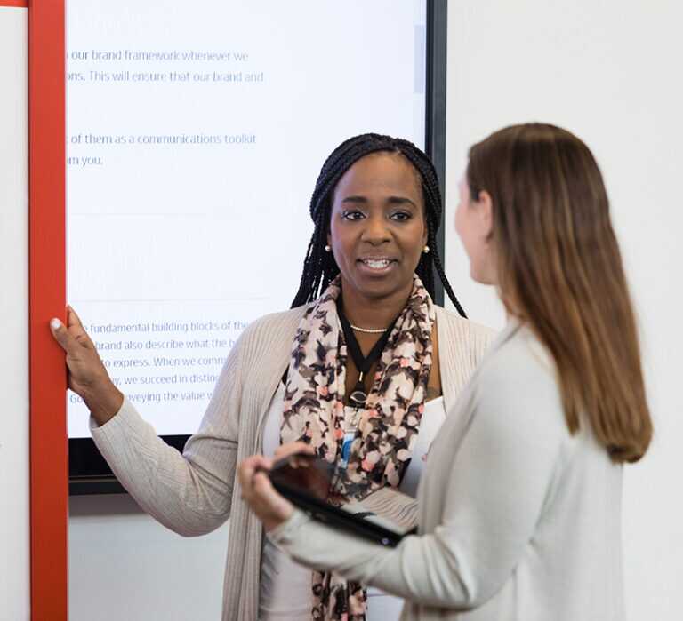 Two female colleagues having a discussion in the workplace